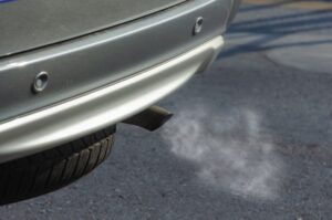 Car tailpipe spitting out exhaust.